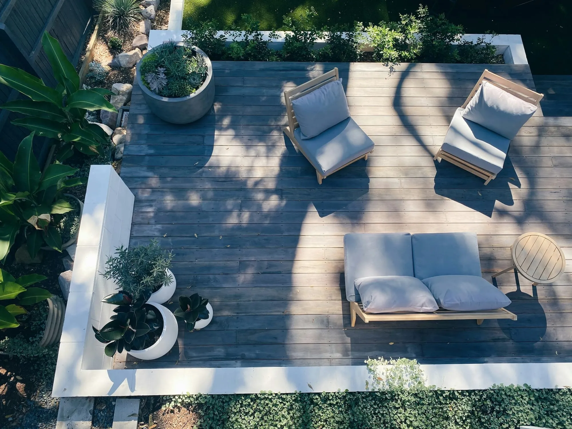 Overhead view of a deck with outdoor furniture and potted plants